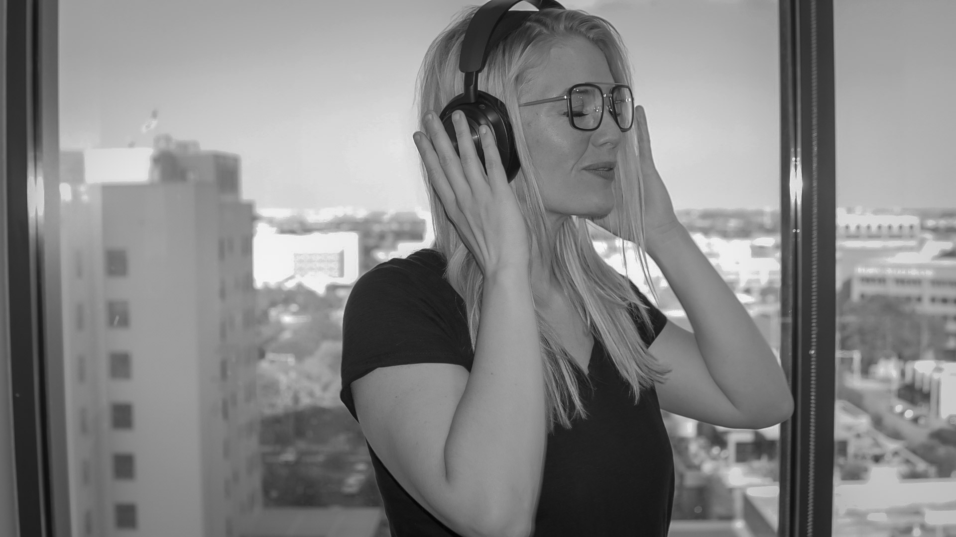 Podcast expert Cassidyy Atkins listening on headphones